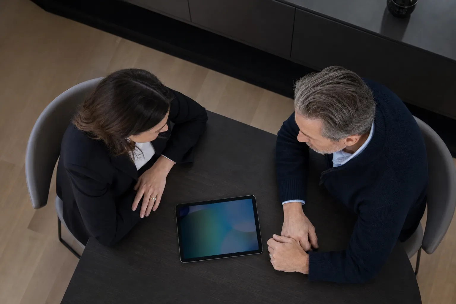 A tablet lying flat at the edge of a meeting table (section 7)